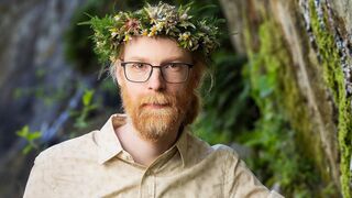 A cinematic photo of Jens, with a flower crown on his head